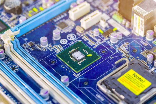 Integrated semiconductor microchip/ microprocessor on blue circuit board representative of the high tech industry and computer science.