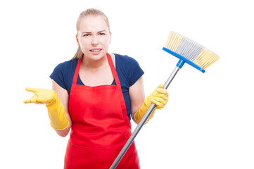 Annoyed cleaning lady with broom