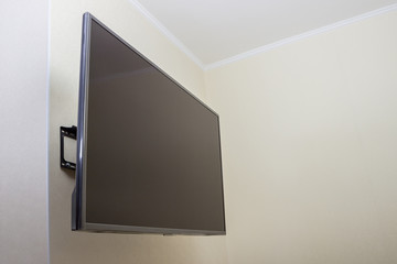 Black LED tv television screen mockup mock up, blank on white wall background