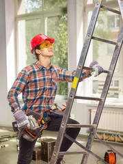The builder is on the ladder.