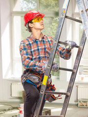 The builder is on the ladder.