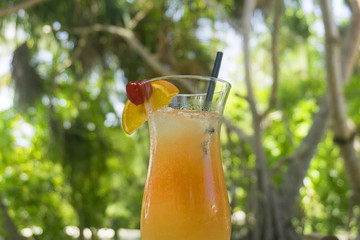 Tropical cocktail with orange and cherry garnish