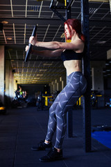 Fototapeta na wymiar Fitness girl exercising with barbell in gym