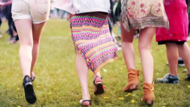 Girls running to main stage at the festival 