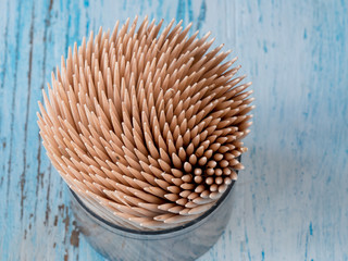 Wooden toothpicks in box. Toothpicks on wooden background