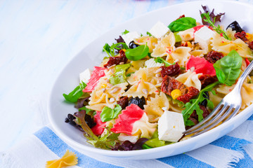 Mediterranean Farfalle salad with dry tomatoes and pine cores