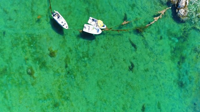 Small boats turquoise green waters Sisimiut Greenland summer drone aerial 4k