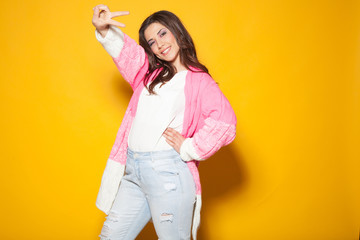 the girl in the pink jacket shows two fingers