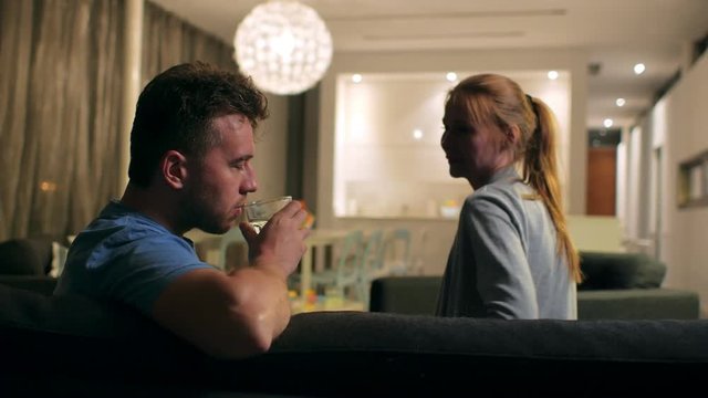 The social problem of alcoholism. Wife trying to stop husband from drinking, it won't work