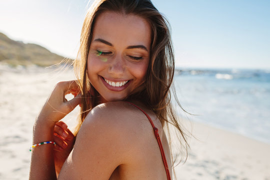 Smiling young woman on the beach.