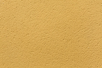 Yellow ochre painted stucco wall. Background texture.