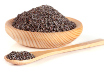 poppy seeds in a wooden bowl and spoon isolated on white background