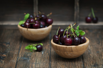 Fresh weet cherry and green mint on the wooden table