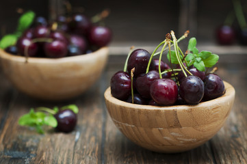 Fresh weet cherry and green mint on the wooden table