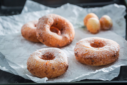 Clouseup of sweet and hot golden donuts ready to eat