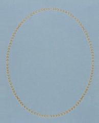 Fabric background with gold embossed oval frame