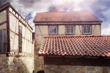Fototapeta na wymiar old medieval houses with red roofs