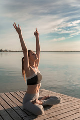 Fototapeta na wymiar Sports lady at the beach make meditate exercises.