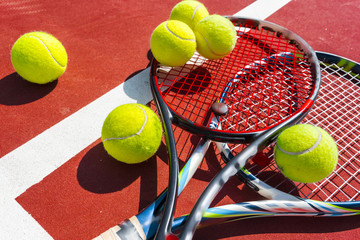 Tennis balls and racket on the grass court