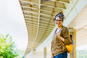 Outdoor lifestyle portrait of glamorous woman posing in city center.