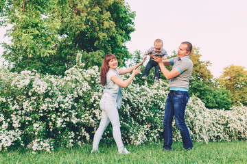 Fototapeta premium Happy male and female playing with children outside