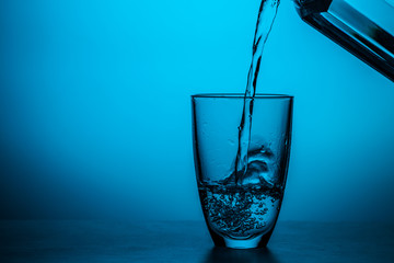 Man pours water from glass