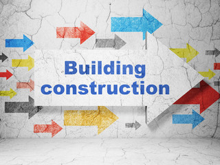 Constructing concept: arrow with Building Construction on grunge wall background