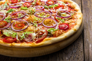 Delicious pizza with with onions, bacon and cherry