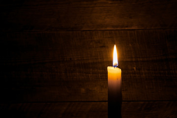 Fototapeta na wymiar beeswax candle on old wooden background