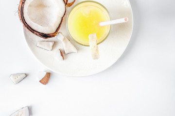 cocktail with coconut on white background top view