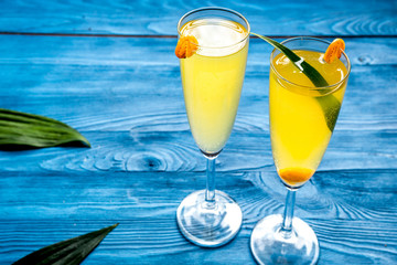 cocktail with physalis in glass on wooden background