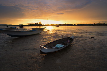 Fototapeta premium Small boat during a beautiful sunset somewhere in Sabah, North Borneo, Asia.