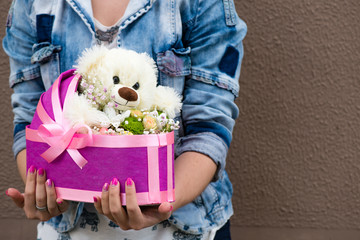 flowers and teddy bear in gift box