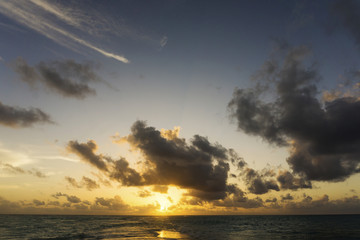 Dramatic sunset over tropical beach and sea