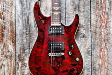 Fototapeta na wymiar Electric red guitar body on wooden background vintage look