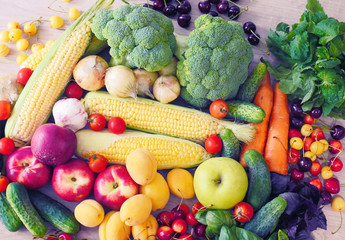 Vegetable abstract composition. Fresh vegetables: broccoli, carrot, corn, cucumber, garlic, onion, potatoes, salad, tomato, basil. Fresh Organic Vegetables. Summer Fruits: cherry, peaches, apricots.