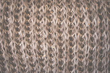 Knitted woolen brown texture background. Macro, closeup. Toned retro.