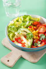 healthy vegan avocado salad with tomatoes and sweetcorn