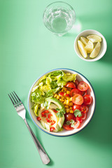 healthy vegan avocado salad with tomatoes and sweetcorn