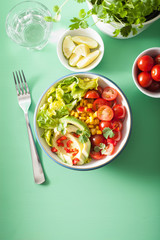 healthy vegan avocado salad with tomatoes and sweetcorn