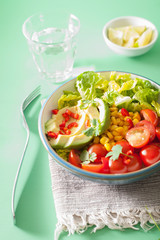 healthy vegan avocado salad with tomatoes and sweetcorn
