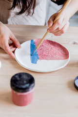 Obraz na płótnie Canvas workshop production of ceramic tableware product painting