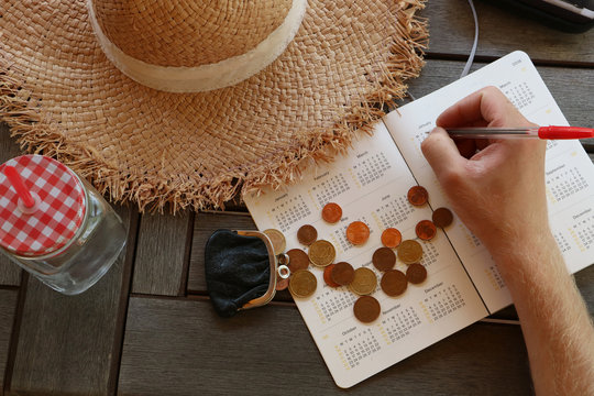 Man is planing travel budget and drinking summer drink