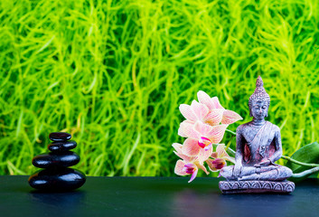 Zen garden background with buddha, orchid flower and zen stones