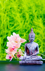 Zen garden background with buddha and orchid flower