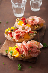 salami bruschetta with roasted peppers goat cheese olives
