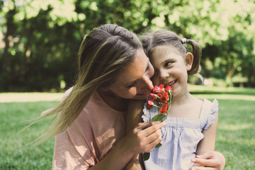 Daughter chose a flower to his mother.