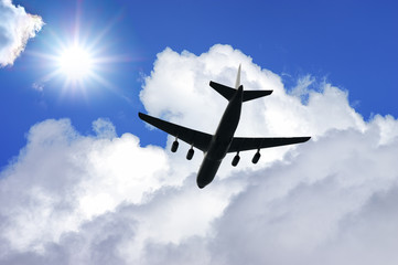 Airplane silhouette in deep blue sky. Airplane travel composition