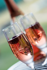 Wine glasses on table at garden in a sunny day