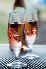Wine glasses on table at garden in a sunny day